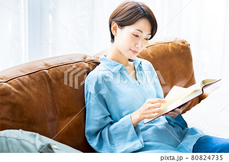 リビングのソファで読書をするミドルの女性 リビングのソファで読書をするミドルの女性 80824735