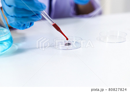 Scientist holding Coronavirus covid-19 infected blood sample tube DNA testing of the blood in the laboratory with blood sample collection tubes and syringe Coronavirus Covid-19 vaccine research. Scientist holding Coronavirus covid-19 infected blood sample tube DNA testing of the blood in the laboratory with blood sample collection tubes and syringe Coronavirus Covid-19 vaccine research. 80827824