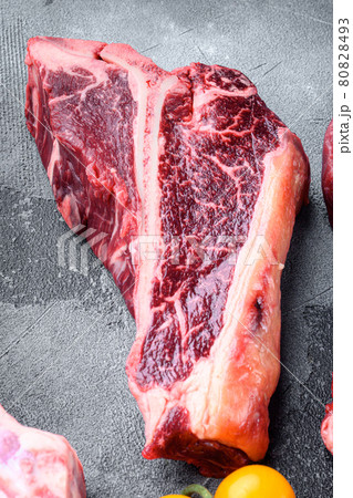 T bone steak raw, on gray stone background T bone steak raw, on gray stone background 80828493