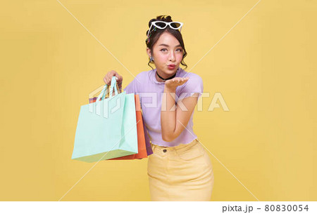 Cheerful happy teen asian woman enjoying shopping, she is carrying shopping bags at the shopping center. Cheerful happy teen asian woman enjoying shopping, she is carrying shopping bags at the shopping center. 80830054
