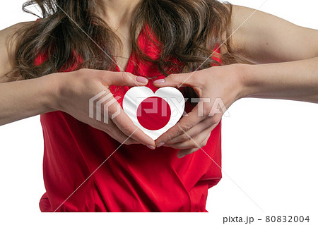 Love Japan The woman holds a heart in the form of the flag of Japan on her chest. Concept of patriotism 80832004