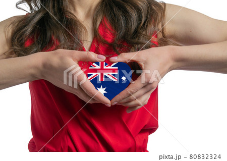 Love Australia. The woman holds a heart in the form of the flag of Australia on her chest. Concept of patriotism 80832324