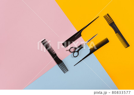 Barber set with combs and scissors on the color pink, yellow, blue paper background Barber set with combs and scissors on the color pink, yellow, blue paper background 80833577