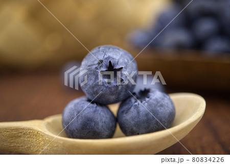Macro composition of blueberries on a wooden spoon Macro composition of blueberries on a wooden spoon 80834226