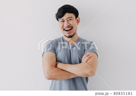 Confident and happy man in blue t-shirt isolated on white background. 80835181