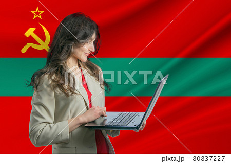 Freelance in Transnistria. Beautiful young woman freelancer uses laptop computer against the background of the flag of Transnistria Freelance in Transnistria. Beautiful young woman freelancer uses laptop computer against the background of the flag of Transnistria 80837227
