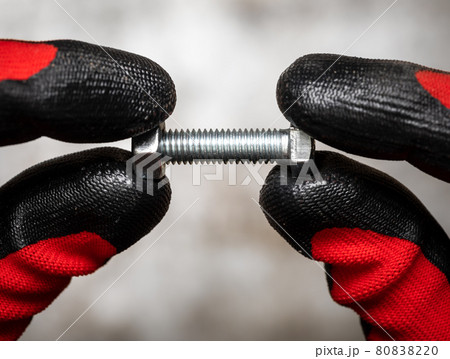 Mechanic holding bolt and nut 80838220