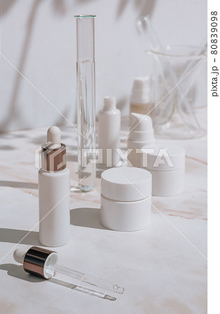 Cosmetic skin care products on white background with plant shadows 80839098