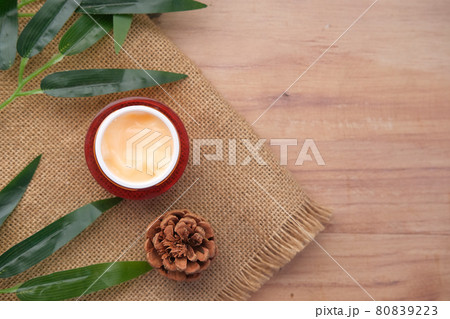 herbal cream cosmetic in a container on table, 80839223