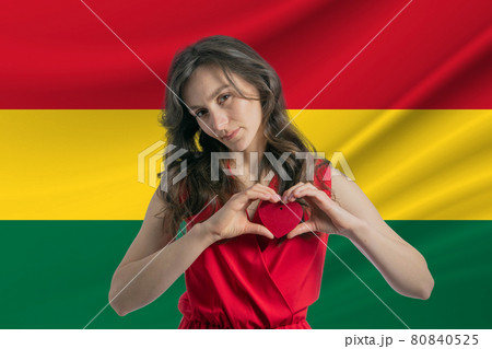 Love Ghana. A girl holds a heart on her chest in her hands against the background of the flag of Ghana. The concept of patriotism Love Ghana. A girl holds a heart on her chest in her hands against the background of the flag of Ghana. The concept of patriotism 80840525