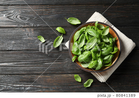 Fresh green basil on black wooden table, flat lay Fresh green basil on black wooden table, flat lay 80841389