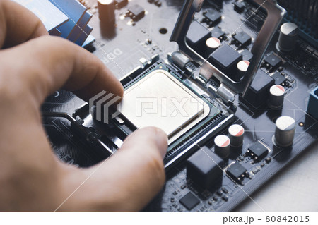 Technician install CPU processor chip to socket 80842015