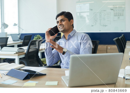 Project Manager Sitting at Office Desk Project Manager Sitting at Office Desk 80843669