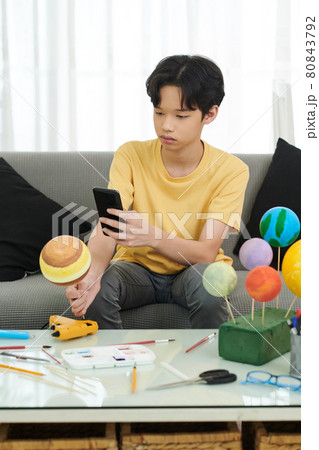 Boy Photographing Jupiter Styrofoam Planet 80843792