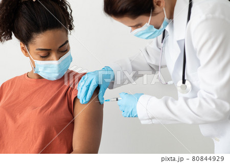 Closeup of female patient getting vaccination against COVID-19 80844929
