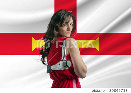 Beauty industry in Guernsey. Happy female hairdresser holding hairdryer against Guernsey flag background 80845753
