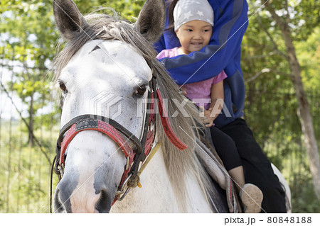 Man riding horse with daughter. Kazakh learns to ride. Ranch concept. Kazakhstan 80848188
