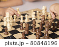 children playing wooden chess on the table 80848196