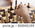 Girls hand moving a king chess, close up 80848199