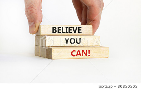 Believe you can symbol. Wooden blocks with words 'Believe you can'. Businessman hand. Beautiful white background. Copy space. Business, motivational and believe you can concept. 80850505