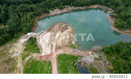 Excavator or bulldozer at work on clay mining site. Aerial view taken with drone 80850852