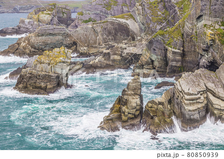 Rough cliff line at Mizen head lighthouse in southern west Ireland during daytime Rough cliff line at Mizen head lighthouse in southern west Ireland during daytime 80850939