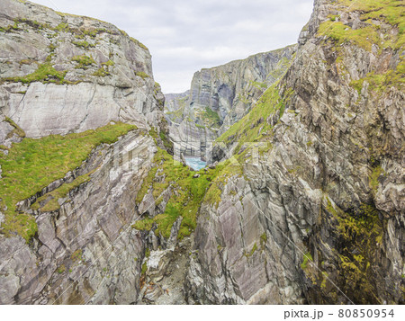 Rough cliff line at Mizen head lighthouse in southern west Ireland during daytime Rough cliff line at Mizen head lighthouse in southern west Ireland during daytime 80850954