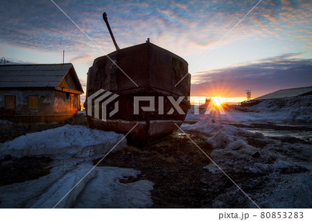 Abandoned ship ashore near an old house. 80853283