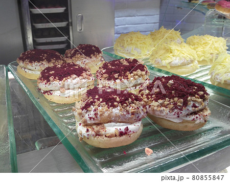 SEREMBAN, MALAYSIA -SEPTEMBER 18, 2016: Racks of assorted doughnuts ready for sale. Sweet an delicious. SEREMBAN, MALAYSIA -SEPTEMBER 18, 2016: Racks of assorted doughnuts ready for sale. Sweet an delicious. 80855847