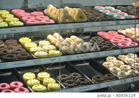 SELANGOR, MALAYSIA -MAY 30, 2016: Donut on display in a mirrored shelf. Displayed for sale fo the costumer. Priced tagged.  80856129