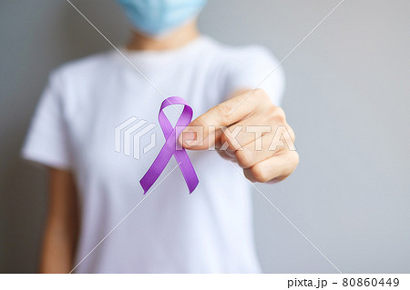 Hand holding purple Ribbon for Pancreatic, Esophageal, Testicular cancer, world Alzheimer, epilepsy, lupus, Sarcoidosis, Fibromyalgia and domestic violence Awareness month. World cancer day concept 80860449