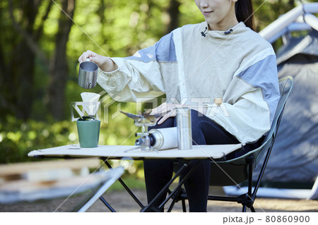 森のキャンプ場でドリップコーヒーを淹れる女性 森のキャンプ場でドリップコーヒーを淹れる女性 80860900