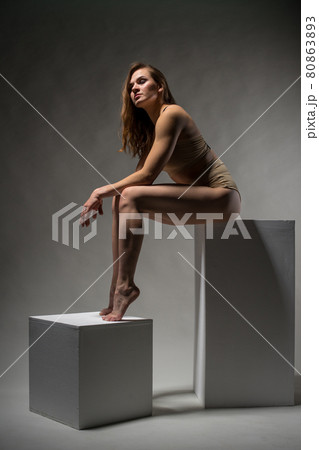 Beautiful sporty girl posing on cubes 80863893