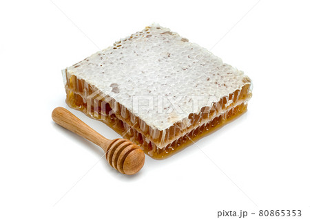 Fresh Honeycomb slice and wooden honey dipper isolated on white background Fresh Honeycomb slice and wooden honey dipper isolated on white background 80865353