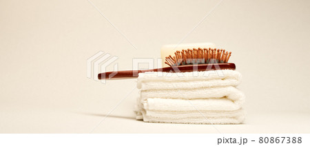 Hairbrush and towels at light background. Minimalistic wellness concept 80867388