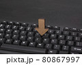 Computer keyboard and wooden arrow to down. Loading data concept 80867997