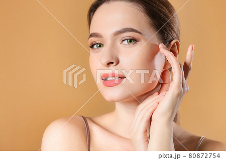 Beautiful portrait of a pretty woman with an orange background. Beautiful portrait of a pretty woman with an orange background. 80872754