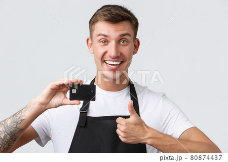 Cafe and restaurants, coffee shop owners and retail concept. Cheerful handsome salesman, store clerk in black apron showing thumbs-up in approval, recommend paying for credit card Cafe and restaurants, coffee shop owners and retail concept. Cheerful handsome salesman, store clerk in black apron showing thumbs-up in approval, recommend paying for credit card 80874437