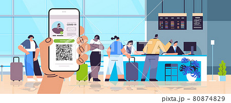 hand holding smartphone with digital immunity passport with qr code on screen risk free covid-19 pandemic hand holding smartphone with digital immunity passport with qr code on screen risk free covid-19 pandemic 80874829