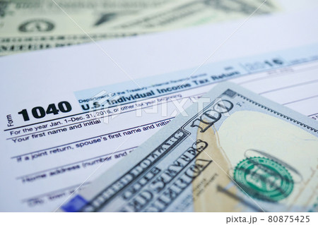 Tax Return form 1040 and dollar banknote : U.S. Individual Income. Tax Return form 1040 and dollar banknote : U.S. Individual Income. 80875425