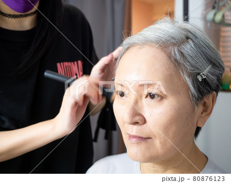 Senior asian woman and make up artist. Senior asian woman and make up artist. 80876123