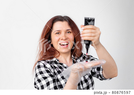 Young woman dyes her hair at home. Bright hair coloring concept. Young woman dyes her hair at home. Bright hair coloring concept. 80876597
