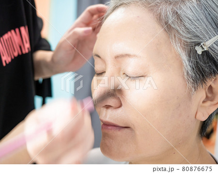 Senior asian woman and make up artist. Senior asian woman and make up artist. 80876675