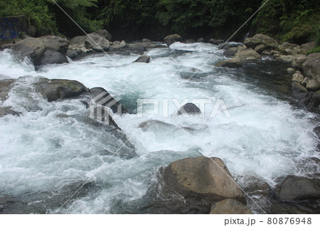river water flows in the tropical forest in Indonesia. this river is cool and beautiful. 80876948