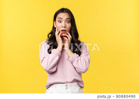 People emotions, lifestyle and fashion concept. Shocked and concerned insecure asian woman react to bad shocking news, gasping and touching face, stare anxious at camera, yellow background People emotions, lifestyle and fashion concept. Shocked and concerned insecure asian woman react to bad shocking news, gasping and touching face, stare anxious at camera, yellow background 80880490