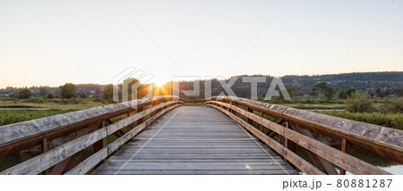 Bridge going over a river in a city park. Bridge going over a river in a city park. 80881287