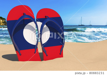 Flip flops with Laotian flag on the beach. Laos resorts, vacation, tours, travel packages concept. 3D rendering Flip flops with Laotian flag on the beach. Laos resorts, vacation, tours, travel packages concept. 3D rendering 80883231
