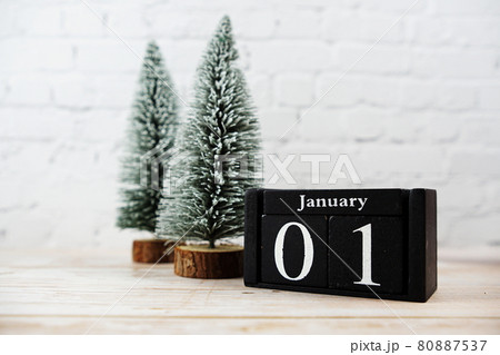 January 1st on the wooden calendar with little christmas tree on white brick wall background January 1st on the wooden calendar with little christmas tree on white brick wall background 80887537