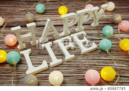 Happy Life alphabet letter with LED cotton balls on wooden background 80887785