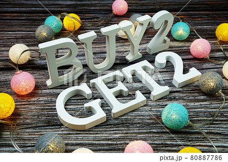 Buy 2 Get 2 Word alphabet letters on wooden background 80887786